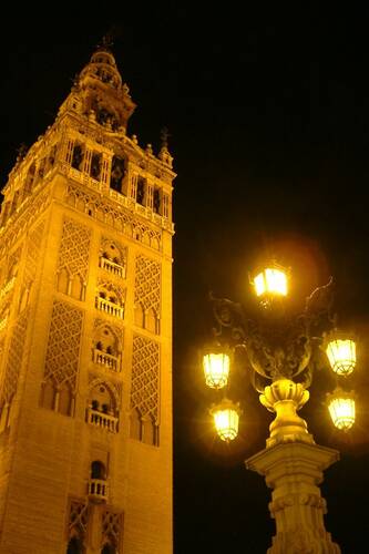 photographer Bitten by the Bug architecture  photo. la giralda was built as the minaret of the central mosque in moorish seville  construction began in 1184 and was completed 14 years later  it was modelled on the minaret of the  kutubiyyah mosque in marrakech